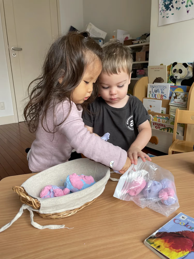 Children move toward the pond on uneven stone steps, watching one another.